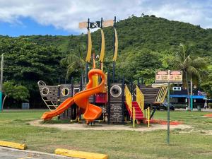 a playground with a slide in a park at Casa Rosado @ Villa Marina Fajardo Pool Yunque in Fajardo