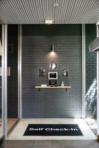 a black brick wall with a shelf on a wall at Canberra Accommodation Centre in Canberra