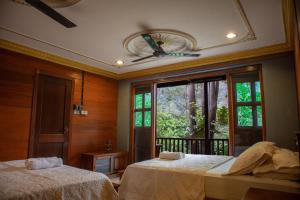 a bedroom with two beds and a window at Deserenity in Seremban