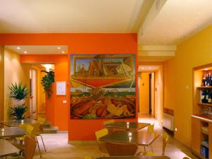 a restaurant with tables and a painting on the wall at Albergo Ristorante Corsini in Pavullo nel Frignano