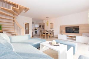 a living room with blue couches and a table at Marina 22-B in Cuxhaven