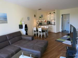 a living room with a couch and a kitchen at Lord Nelson 119 in Döse