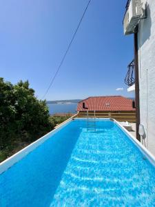 a view of a swimming pool from a house at Apartment Nadia in Lokva Rogoznica