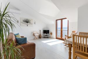 a living room with a couch and a view of the ocean at Apartment Nadia in Lokva Rogoznica