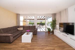 a living room with a couch and a flat screen tv at Villa Divine in Vodice