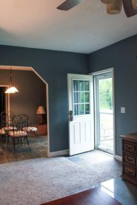 a room with a door and a dining room with a table at Dartt's Park Flat in Owatonna