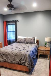 a bedroom with a bed and a window at Dartt's Park Flat in Owatonna