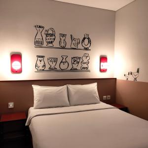 Posteľ alebo postele v izbe v ubytovaní Kotta GO Yogyakarta