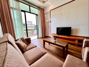 a living room with a couch and a flat screen tv at NEW 6pax 3BR Sunrise view 100m Attractive Places Kea Farm in Cameron Highlands