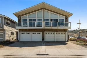 a large house with two garage doors at @ Marbella Lane – Home with Majestic Ocean Views in Pacifica