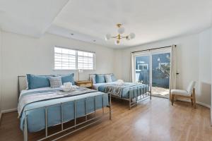 a bedroom with two beds and a window at @ Marbella Lane – Home with Majestic Ocean Views in Pacifica