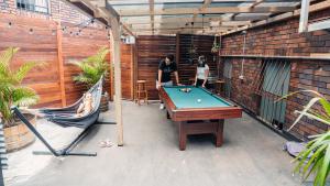 a patio with a pool table and a hammock at Mad Monkey Downtown in Sydney