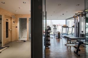 a gym with treadmills and machines in a building at VOQUE Hotel & Serviced Residence Sukhumvit 51 - SHA Plus in Bangkok
