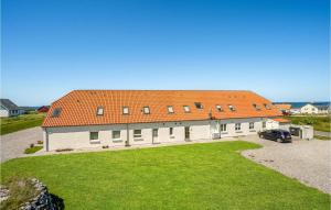a large white building with an orange roof at Awesome Apartment In Lemvig With Kitchen in Lemvig