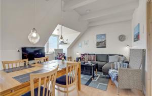 a dining room and living room with a table and chairs at Awesome Apartment In Lemvig With Kitchen in Lemvig