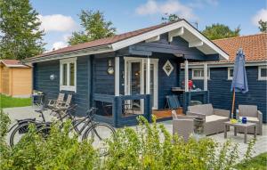 a blue house with a bike parked in front of it at Cozy Home In Kalundborg With Kitchen in Kalundborg