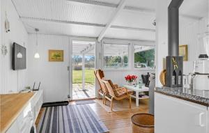 a kitchen with white walls and a table and chairs at Gorgeous Home In Gilleleje in Gilleleje