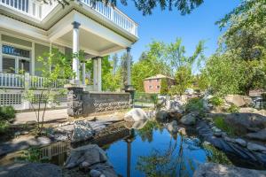 a home with a pond in front of a house at Entire Main level of Beautiful Historic Home in Spokane