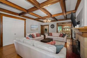 a living room with two white couches and a fireplace at Entire Main level of Beautiful Historic Home in Spokane +44 photos