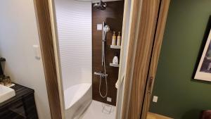 a bathroom with a shower with a glass door at Sapporo - House - Vacation STAY 88283 in Sapporo