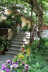 a garden with flowers in front of a building at Locanda Monte San Giorgio in Piossasco