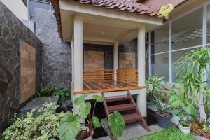 a porch of a house with a wooden deck at RedDoorz Syariah near Universitas Jember in Jember