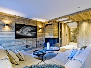 a living room with a couch and a fireplace at Appartement chic Méribel - skis aux pieds, cheminée & parking - FR-1-613-40 in Méribel