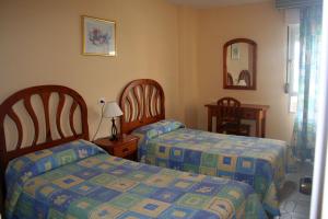 Ein Bett oder Betten in einem Zimmer der Unterkunft Apartamentos Minerva Jupiter