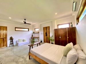 Postel nebo postele na pokoji v ubytování Secret Spot Siargao