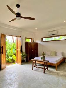 a bedroom with a bed and a ceiling fan at Secret Spot Siargao in General Luna