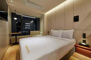 a large white bed in a room with a window at N285 Hotel Insadong in Seoul