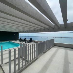 a balcony with a swimming pool on a building at Apartamento Reñaca Live in Viña del Mar