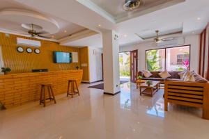 a living room with a bar and a couch at Dhiguveli Breeze in Dhigurah