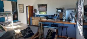 a kitchen with a counter and a refrigerator at Blue Space Beach house in Port Shepstone
