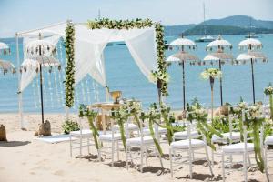 a wedding on the beach with chairs and umbrellas at Zazen Boutique Resort & Spa in Bophut