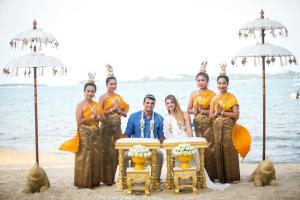 a group of people standing around a table on the beach at Zazen Boutique Resort & Spa in Bophut