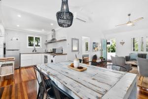 a kitchen and living room with a large table at Bon Cottage in Woorim