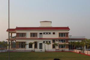 a large white building with a red roof at Flamingo Club and Resort Una 3 Km Away from Diu Check Post in Diu