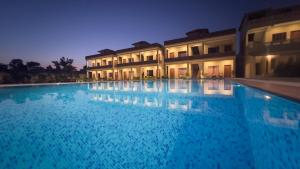 a swimming pool in front of a building at night at RajBagh by Aaryam in Sawāi Mādhopur