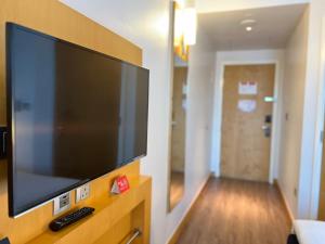 a large flat screen tv on a wall in a room at Ibis One Central - World Trade Centre Dubai in Dubai