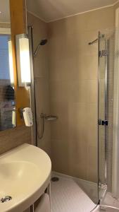 a bathroom with a shower and a white sink at Ibis One Central - World Trade Centre Dubai in Dubai
