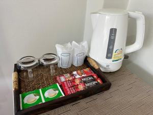 a tray with a coffee maker next to a coffeemaker at Plearn Khaoyai Resort in Mu Si
