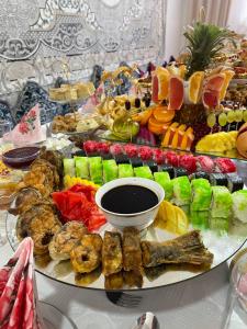 a platter of food on top of a table at Guesthouse Gulmira in Bokonbayevo