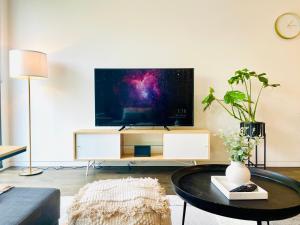 a living room with a tv and a coffee table at Your home on Glover St Sth Melbourne (With Parking) in Melbourne