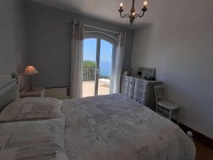 a bedroom with a large bed and a large window at Maison Rayol-Canadel-sur-Mer, 5 pièces, 9 personnes - FR-1-308-142 in Rayol-Canadel-sur-Mer