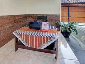 un banco con un portátil sentado encima en SPOT ON 91981 Diwi Homestay, en Tjakranegara