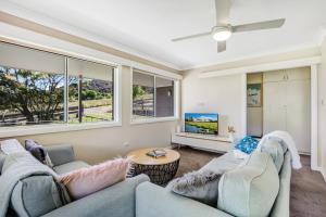 a living room with two couches and a tv at Wandi Bright View in Wandiligong
