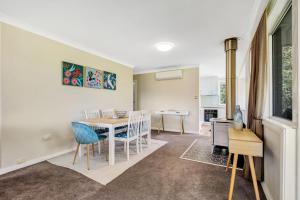a kitchen and dining room with a table and chairs at Wandi Bright View in Wandiligong +11 photos