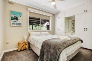 a bedroom with a large bed and a window at Wandi Bright View in Wandiligong