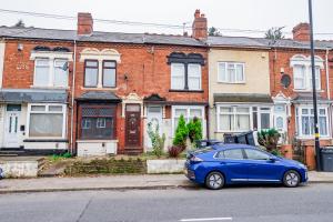a blue car parked in front of a brick house at Free Parking - Large House - Contractor - Leisure in Birmingham